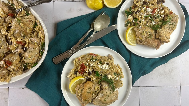 chicken and orzo on plates over napkin