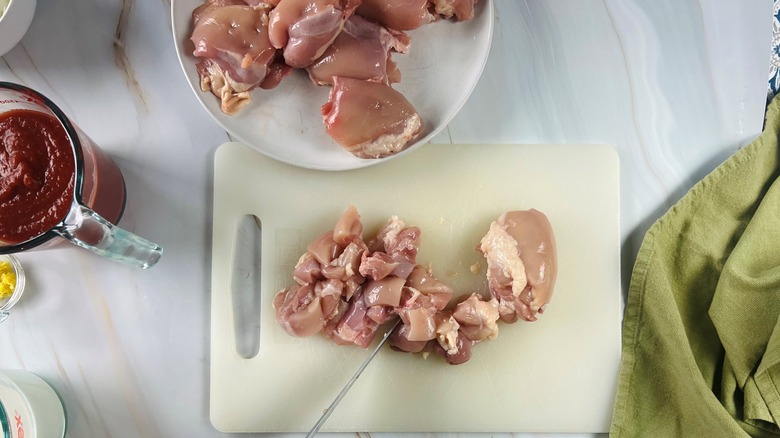 chopped chicken thighs on cutting board
