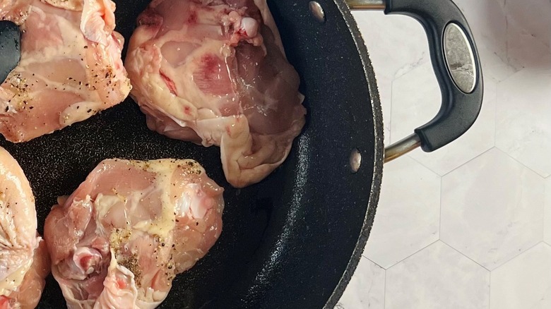 Chicken thighs in a sauté pan