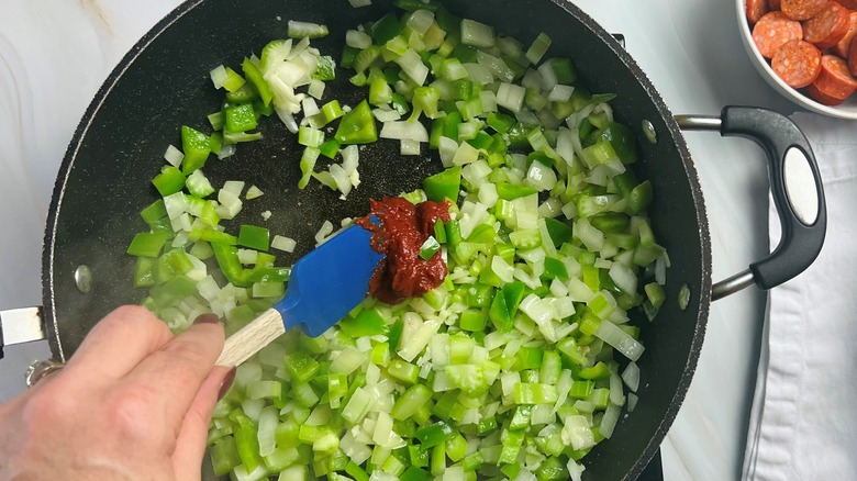 cooking tomato paste with vegetables