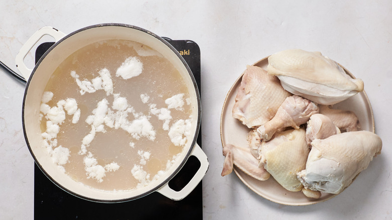 blanched chicken next to pot of water