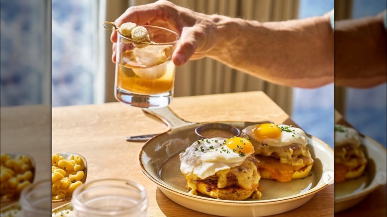 person holding cocktail over a breakfast dish on Royal Caribbean Cruise Line