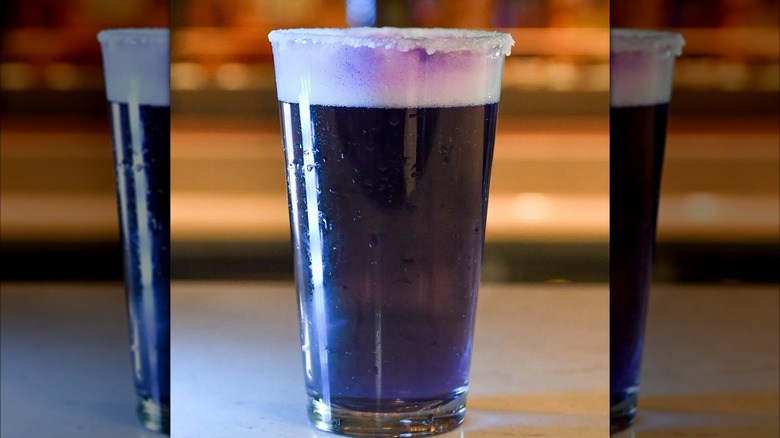 a purple draft beer sitting on the bar on Disney Cruise Line