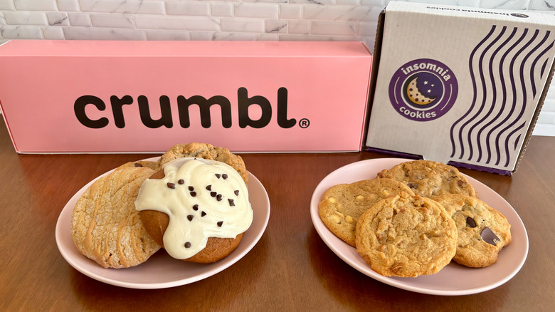 various Crumbl and Insomnia cookies with boxes