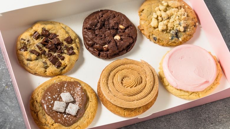 Six Crumbl cookies in a box