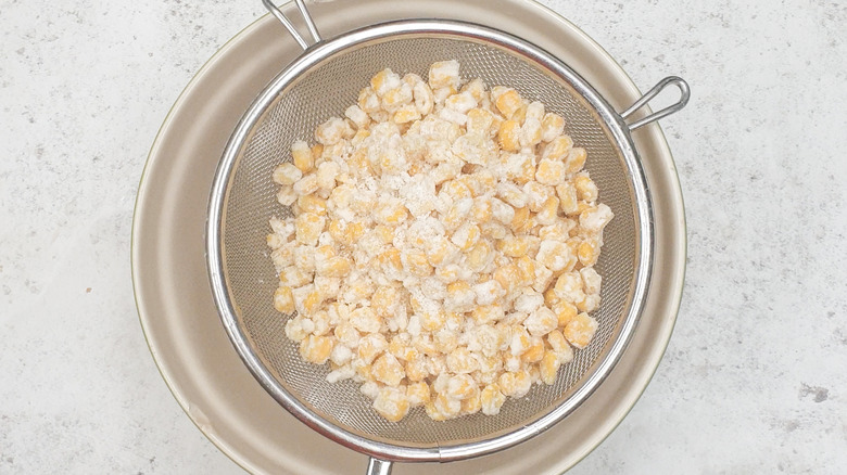 corn kernels in a sieve