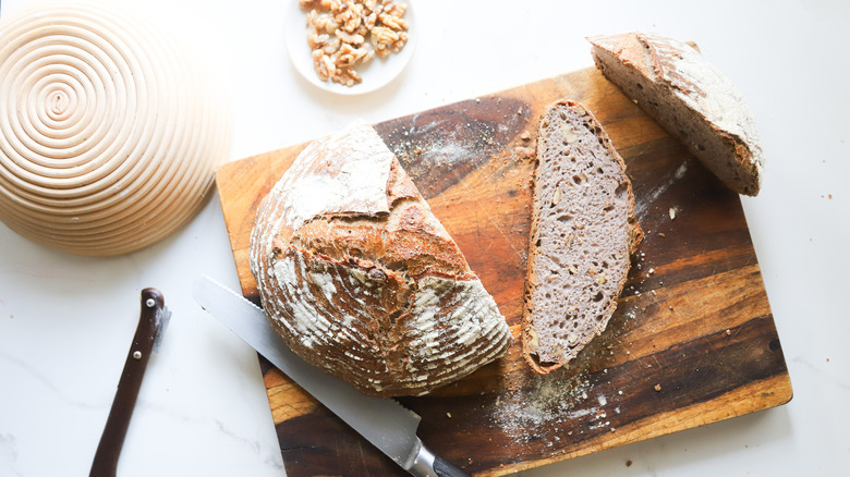 Cutting into fresh sourdough bread