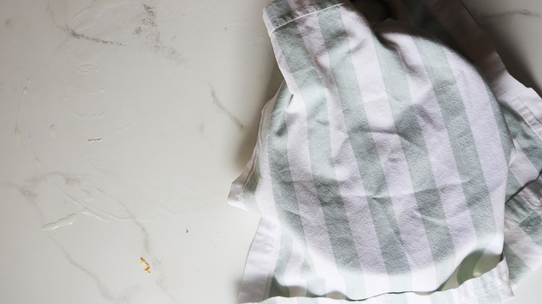 Bowl of dough resting under striped towel