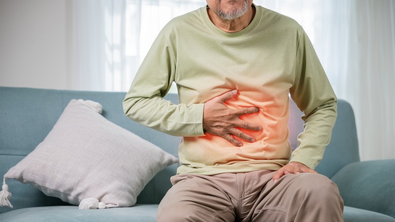 A man holding his stomach in pain