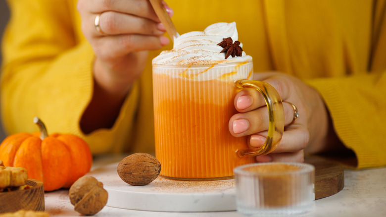 A person holding buttered rum.