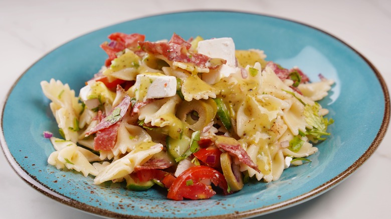 Bowl of pasta with olives, feta, and cured meat