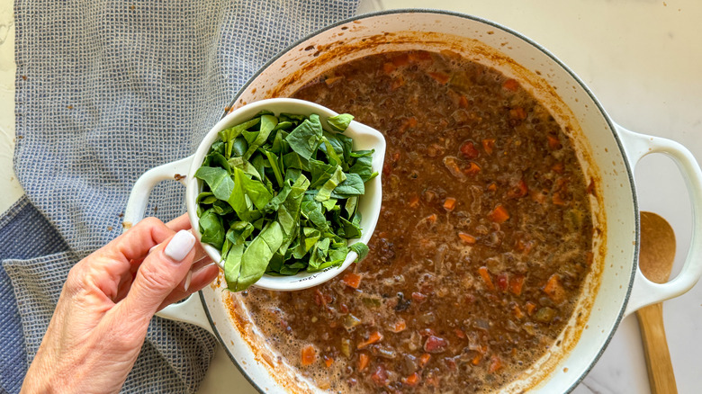 adding spinach to soup