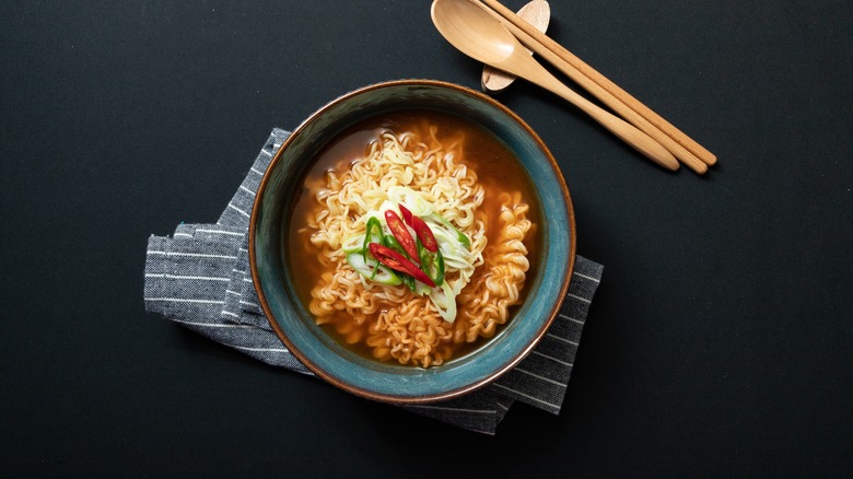 Ramen in a bowl with napkin and utensils 