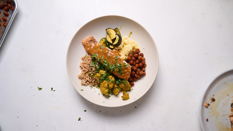 salmon and sauce in grain bowl