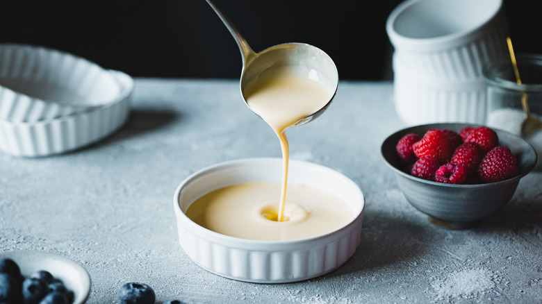 spoon filling dish with custard