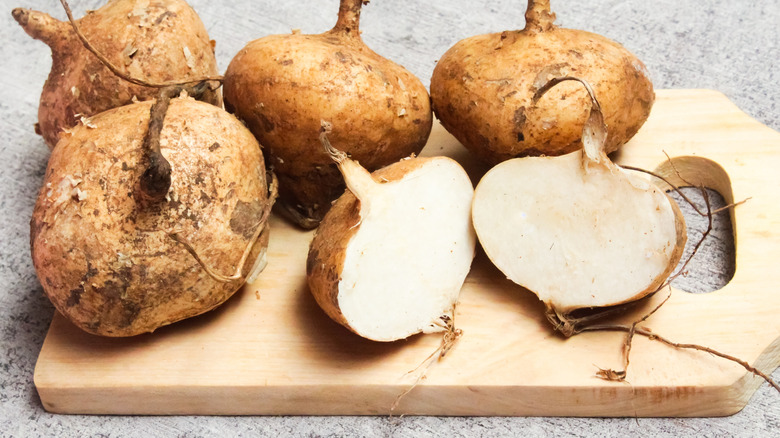 whole and sliced jicama on a cutting board