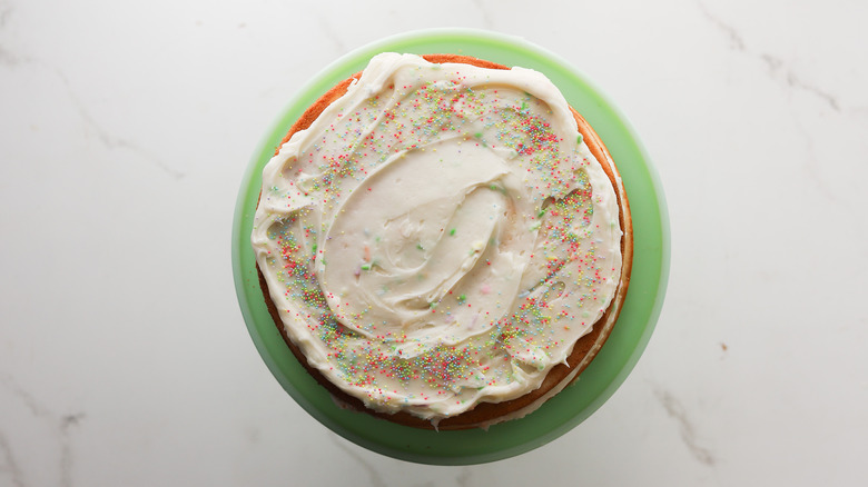 Frosting spread on layered cake