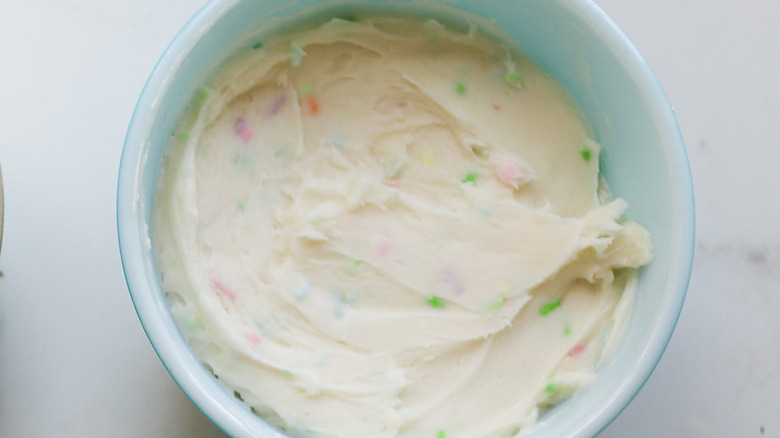 Bowl of sprinkle buttercream frosting