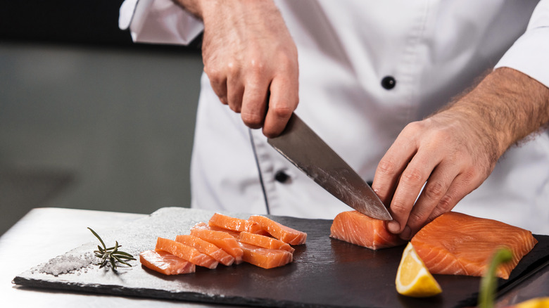 A chef slicing fish