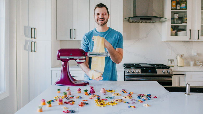 Danny Freeman smiling and making pasta