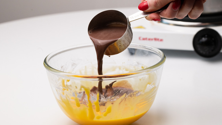 Adding chocolate to milk in a saucepan 