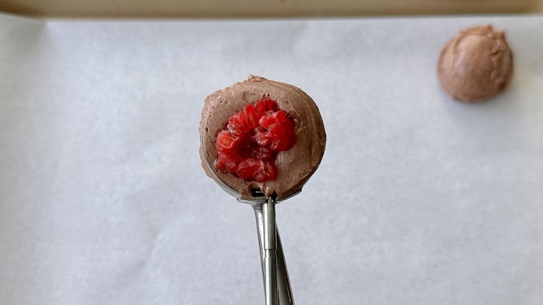 Scoop of chocolate cheesecake with raspberry