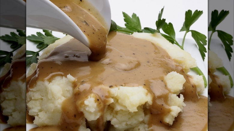 Gravy poured over mashed potatoes