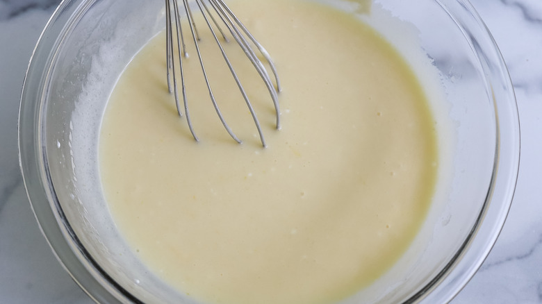 wet ingredients in a bowl with a whisk