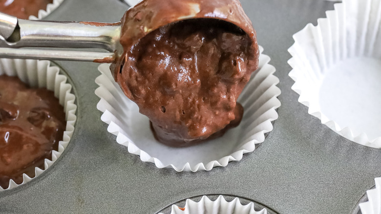 death by chocolate muffin batter being put into a pan