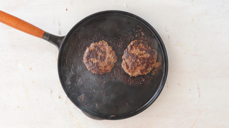 browned beef patties in skillet