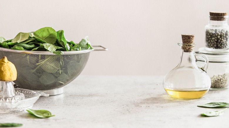 Sieve full of spinach leaves