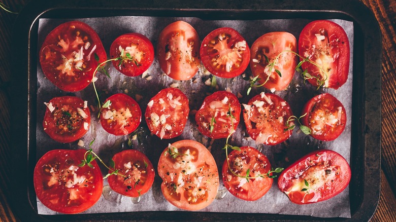 Halved tomatoes on baking sheet