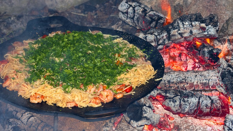 Pasta cooking over a campfire