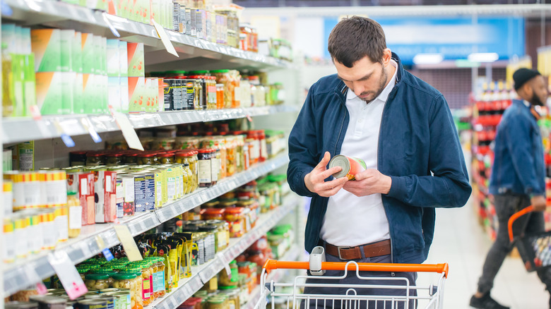 a man looking at a nutrition label in a store