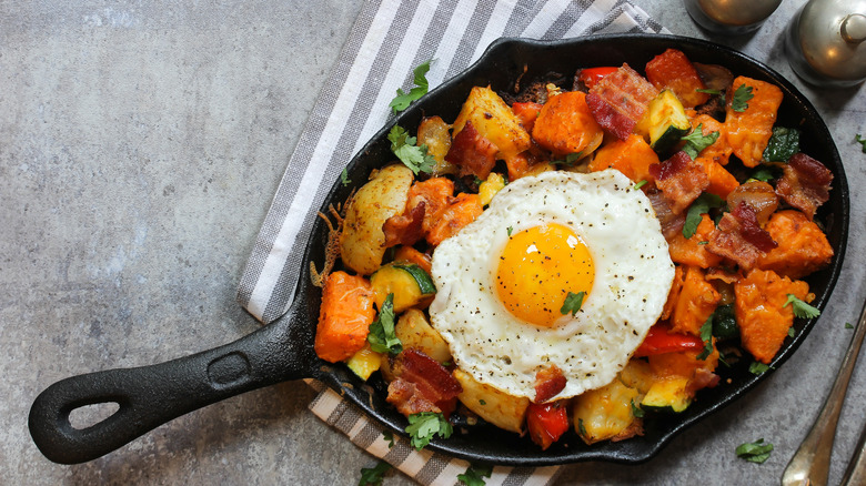 hash in skillet with fried egg