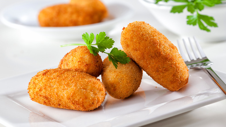 chicken croquetas on white plate