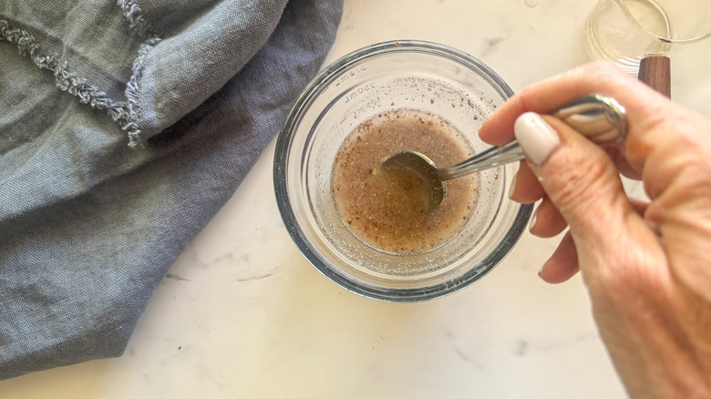 hand stirring the flax water