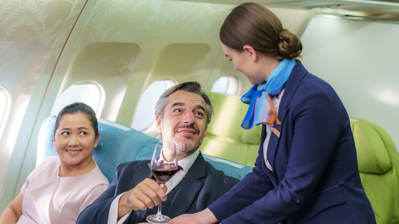 Flight attendant serving passengers