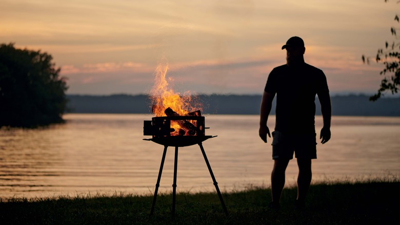 Derek Wolf outdoors wood-burning grill