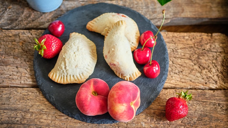 plate of empanadas with fresh fruit