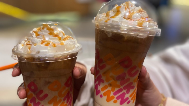 dunkin' iced coffee drinks in two hands