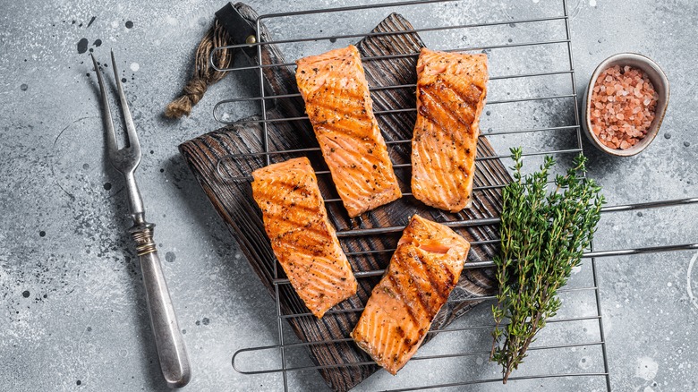 Grilled salmon fillets on wire rack with rosemary