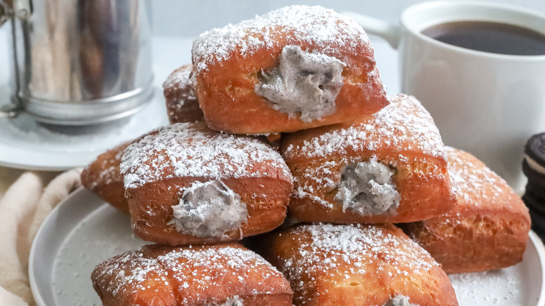 cookies and cream beignets stacked on a plate