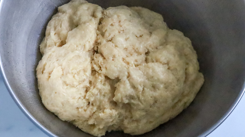 Risen beignet dough in a bowl