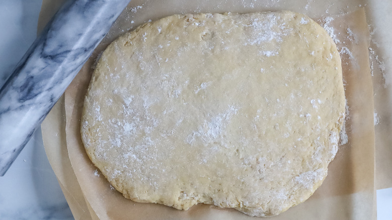 Beignet dough rolled out on a table