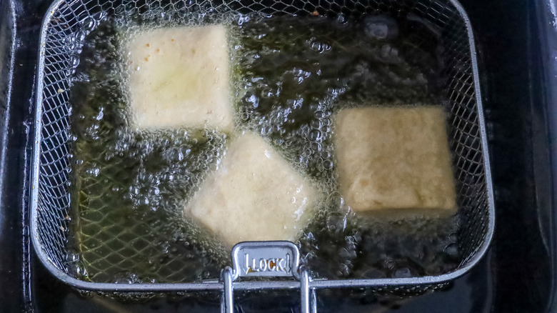 Beignets being fried in oil