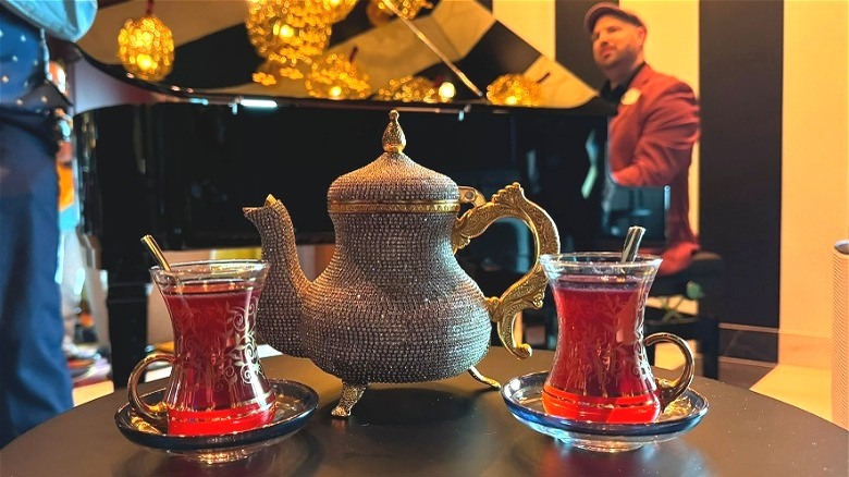 Tea cocktail set served at the Scat Cat lounge onboard the Disney Treasure, piano player in background