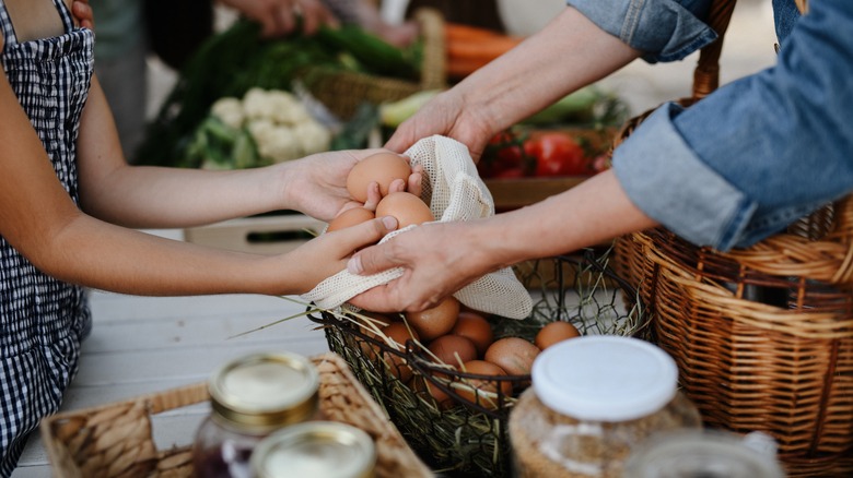 woman buying farmers market eggs