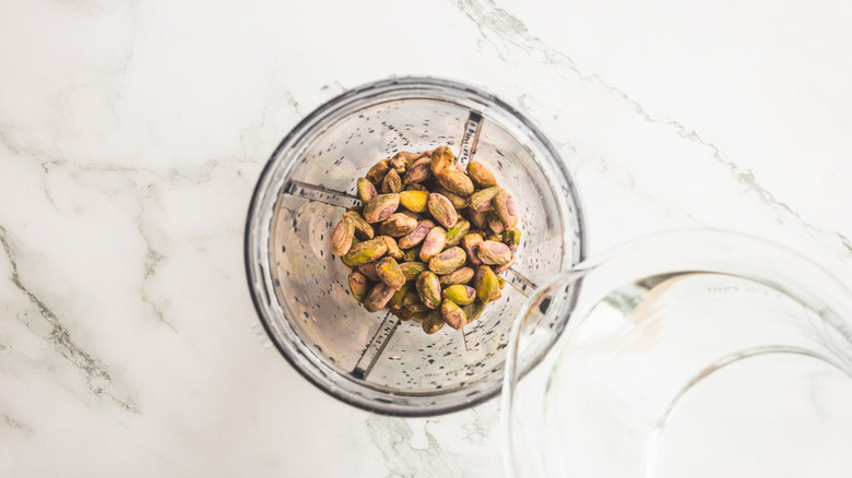 pistachios and water in blender