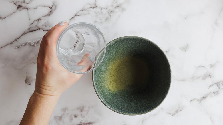 adding water to matcha powder